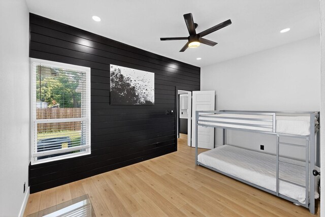 712 W 8th St, Dallas, TX 75208 - bedroom featuring wood finished floors, wood walls, recessed lighting, and ceiling fan