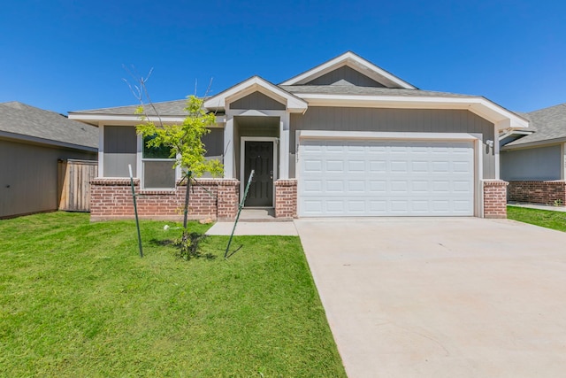 7717 Vineyard Dr, Abilene, TX 79606 - ranch-style house featuring brick siding, concrete driveway, a front lawn, and an attached garage