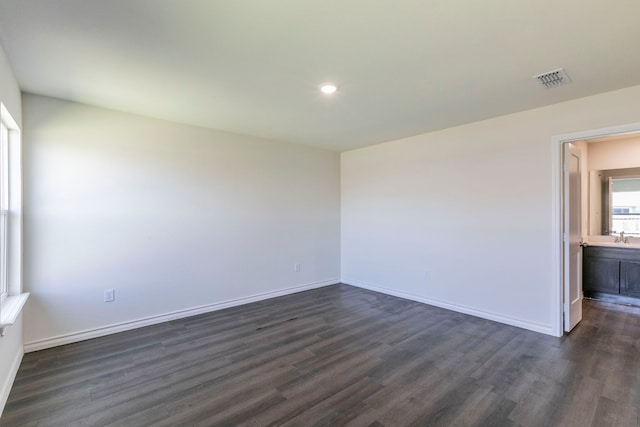 7717 Vineyard Dr, Abilene, TX 79606 - spare room featuring dark wood-type flooring, a sink, baseboards, and recessed lighting