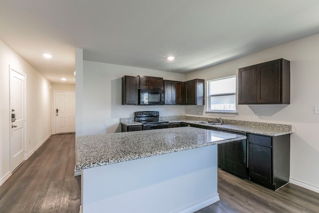 7717 Vineyard Dr, Abilene, TX 79606 - kitchen with black appliances, a sink, dark wood finished floors, a kitchen island, and dark brown cabinetry