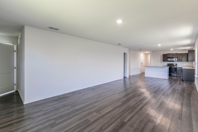7717 Vineyard Dr, Abilene, TX 79606 - unfurnished living room with dark wood-style flooring, recessed lighting, and baseboards
