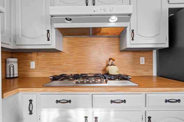 1610 Alpine Pass, Lewisville, TX 75077 - kitchen with range hood, stainless steel gas cooktop, tasteful backsplash, and light countertops