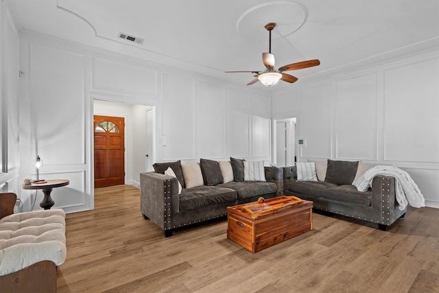 1610 Alpine Pass, Lewisville, TX 75077 - living area featuring a decorative wall, a ceiling fan, and light wood-style flooring