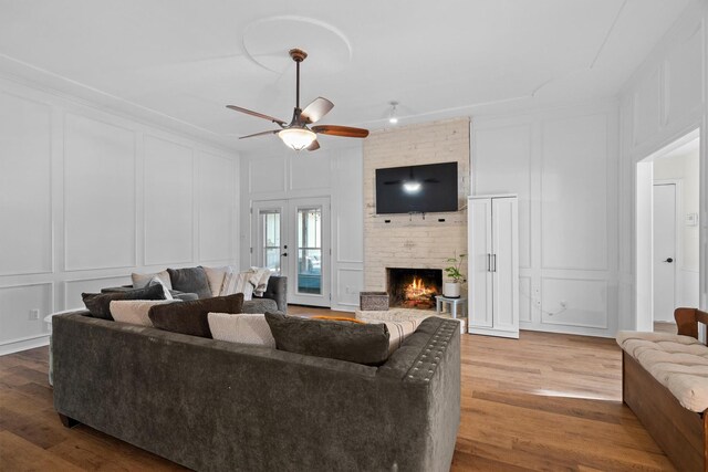 1610 Alpine Pass, Lewisville, TX 75077 - living area with a decorative wall, wood finished floors, ceiling fan, and a brick fireplace