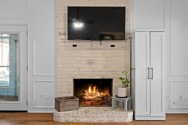 1610 Alpine Pass, Lewisville, TX 75077 - detailed view of wood finished floors and a brick fireplace