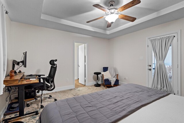 1610 Alpine Pass, Lewisville, TX 75077 - carpeted bedroom with a tray ceiling, an office area, and ceiling fan