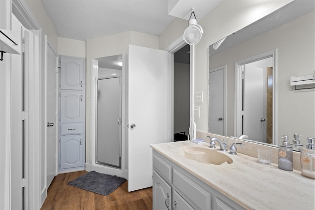 1610 Alpine Pass, Lewisville, TX 75077 - bathroom featuring a stall shower, wood finished floors, and vanity