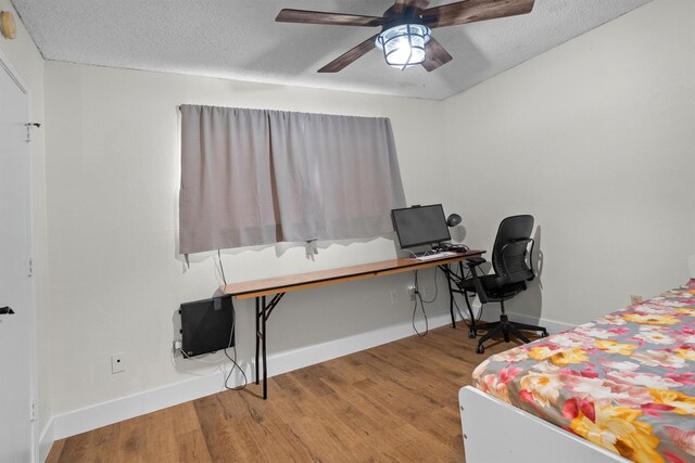 1610 Alpine Pass, Lewisville, TX 75077 - bedroom featuring wood finished floors, a desk, a textured ceiling, and ceiling fan