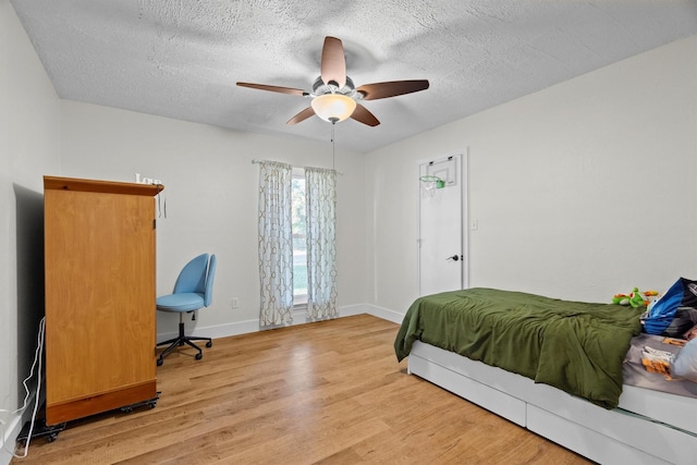 1610 Alpine Pass, Lewisville, TX 75077 - bedroom featuring light wood-style flooring, a textured ceiling, and ceiling fan