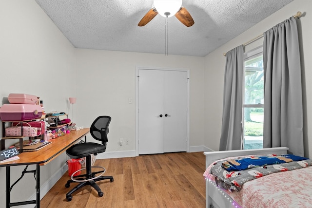 1610 Alpine Pass, Lewisville, TX 75077 - bedroom with a textured ceiling, wood finished floors, an office area, and ceiling fan
