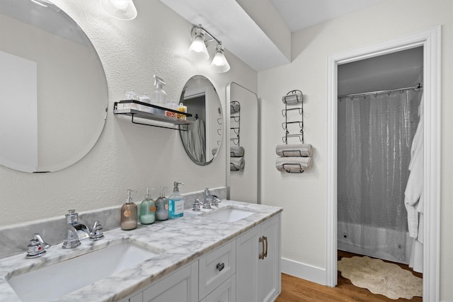 1610 Alpine Pass, Lewisville, TX 75077 - full bath with wood finished floors, double vanity, and a shower with curtain