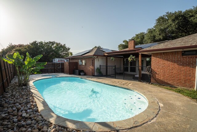 1610 Alpine Pass, Lewisville, TX 75077 - view of pool with a fenced backyard, a pool with connected hot tub, and a patio area