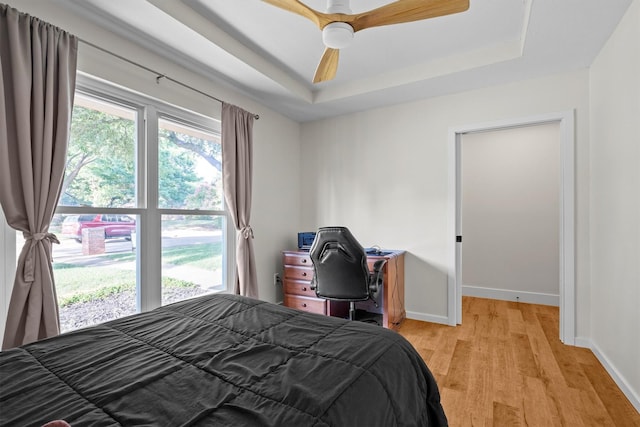 1610 Alpine Pass, Lewisville, TX 75077 - bedroom with a raised ceiling, light wood-type flooring, and ceiling fan