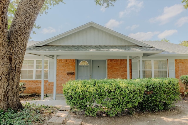 2712 Larkin Ave, Fort Worth, TX 76133 - view of front of house with brick siding, roof with shingles, and a porch