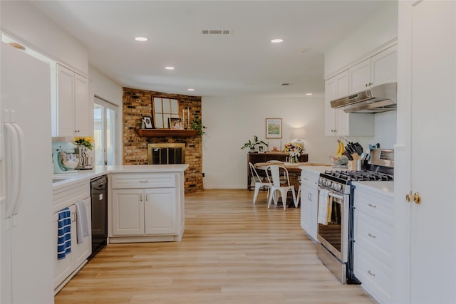 2712 Larkin Ave, Fort Worth, TX 76133 - kitchen featuring stainless steel gas range, under cabinet range hood, dishwasher, freestanding refrigerator, and white cabinetry