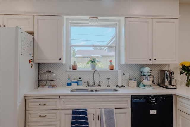 2712 Larkin Ave, Fort Worth, TX 76133 - kitchen featuring dishwasher, freestanding refrigerator, a sink, backsplash, and white cabinetry