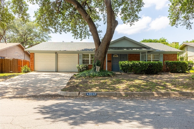 2712 Larkin Ave, Fort Worth, TX 76133 - ranch-style home with an attached garage, concrete driveway, and brick siding