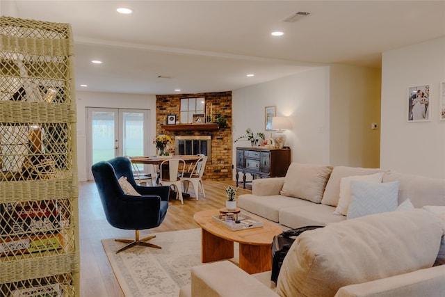 2712 Larkin Ave, Fort Worth, TX 76133 - living room with light wood finished floors, a brick fireplace, recessed lighting, and french doors