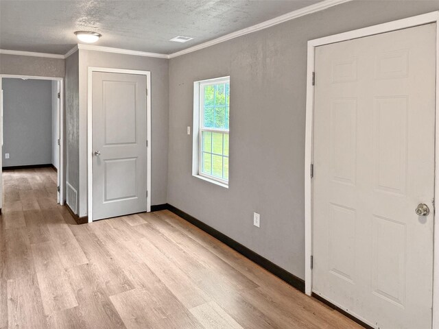 18023 Lakeview Blvd, Mabank, TX 75156 - unfurnished room with light wood-style flooring, baseboards, crown molding, and a textured ceiling