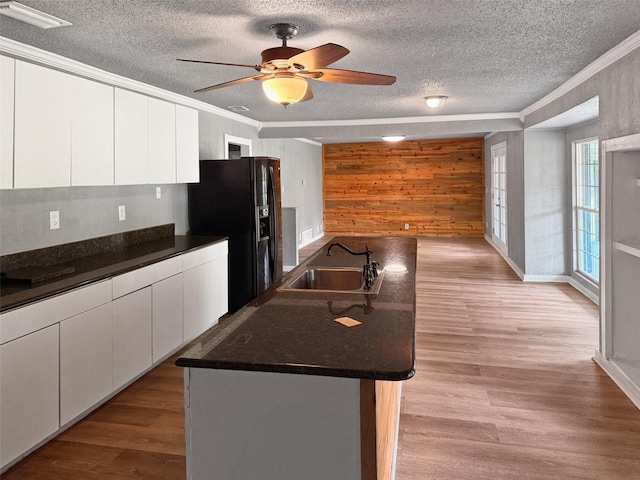 18023 Lakeview Blvd, Mabank, TX 75156 - kitchen with a sink, a textured ceiling, dark countertops, crown molding, and wooden walls