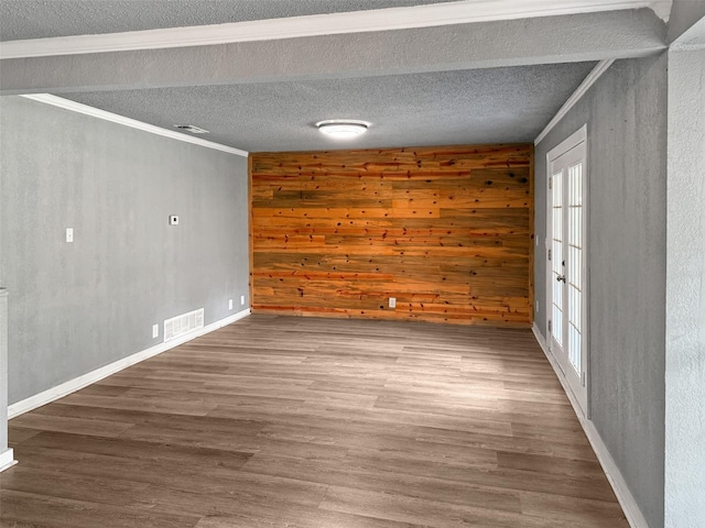 18023 Lakeview Blvd, Mabank, TX 75156 - spare room with crown molding, wood walls, wood finished floors, baseboards, and a textured ceiling