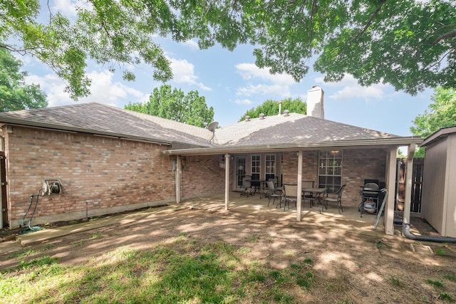 2510 High Pointe Blvd, Mckinney, TX 75071 - rear view of property with brick siding, a chimney, a patio, and roof with shingles