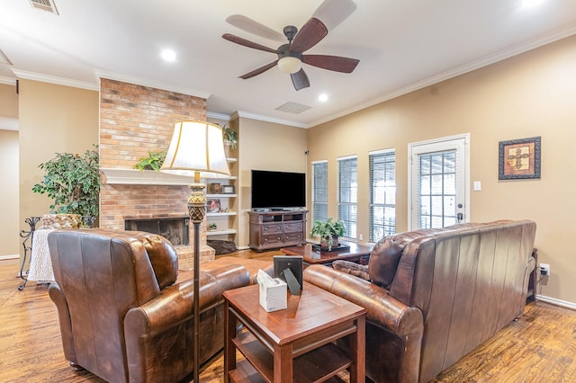 2510 High Pointe Blvd, Mckinney, TX 75071 - living area featuring a ceiling fan, a brick fireplace, ornamental molding, wood finished floors, and recessed lighting