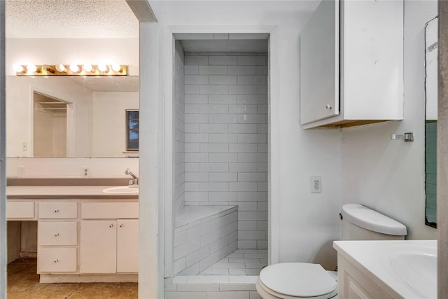635 N Center St, Blossom, TX 75416 - bathroom featuring vanity, toilet, a shower stall, tile patterned flooring, and a textured ceiling