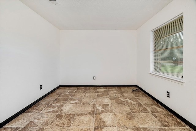 635 N Center St, Blossom, TX 75416 - spare room with stone finish flooring and baseboards