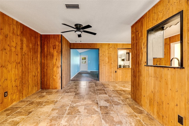 635 N Center St, Blossom, TX 75416 - hallway with wooden walls, a textured ceiling, crown molding, and a sink