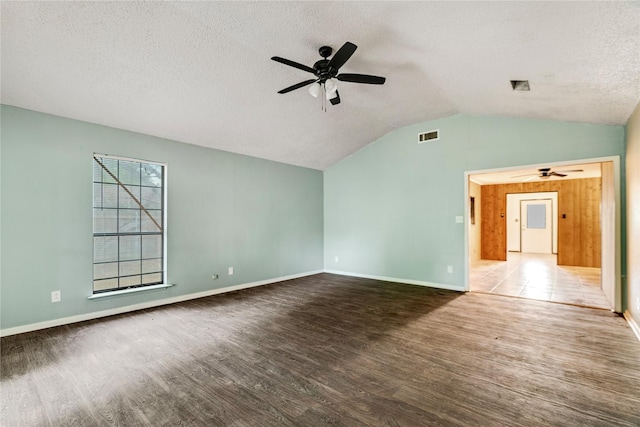 635 N Center St, Blossom, TX 75416 - spare room with a ceiling fan, wood finished floors, vaulted ceiling, a textured ceiling, and baseboards