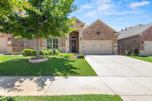 2508 Pioneer Dr, Denton, TX 76210 - view of front of home featuring brick siding, a garage, a front lawn, concrete driveway, and stone siding
