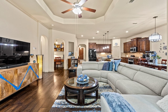 2508 Pioneer Dr, Denton, TX 76210 - living room featuring a ceiling fan, arched walkways, dark wood-style flooring, recessed lighting, and ornamental molding