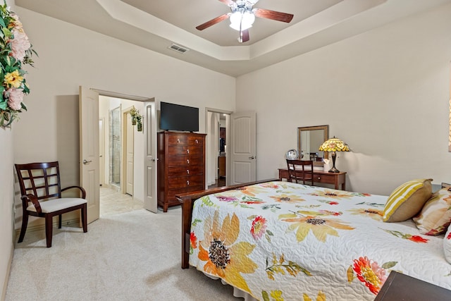 2508 Pioneer Dr, Denton, TX 76210 - bedroom with light colored carpet, a high ceiling, a tray ceiling, and ceiling fan