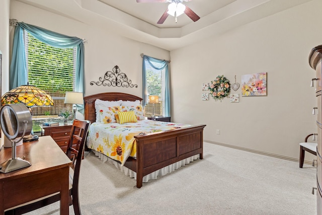 2508 Pioneer Dr, Denton, TX 76210 - bedroom with light carpet, a tray ceiling, and ceiling fan