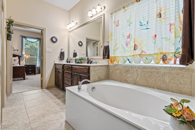 2508 Pioneer Dr, Denton, TX 76210 - full bathroom with double vanity, a garden tub, tile patterned flooring, and connected bathroom
