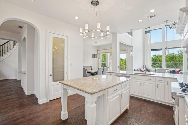 4534 Whispering Lake Dr, Frisco, TX 75036 - kitchen featuring a sink, a center island, light stone counters, white cabinetry, and recessed lighting