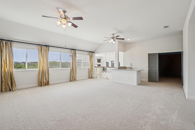 4534 Whispering Lake Dr, Frisco, TX 75036 - unfurnished living room with ceiling fan, a sink, light carpet, baseboards, and lofted ceiling