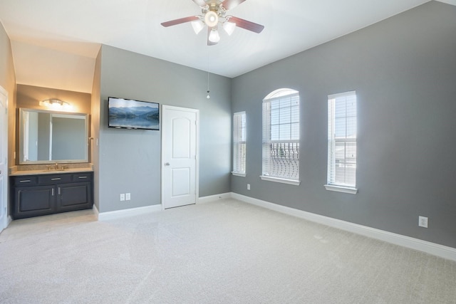 4534 Whispering Lake Dr, Frisco, TX 75036 - unfurnished bedroom with light carpet, a sink, baseboards, connected bathroom, and ceiling fan