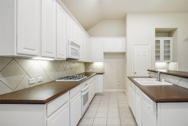 8393 Davis Dr, Frisco, TX 75036 - kitchen featuring white appliances, a sink, dark countertops, backsplash, and white cabinetry
