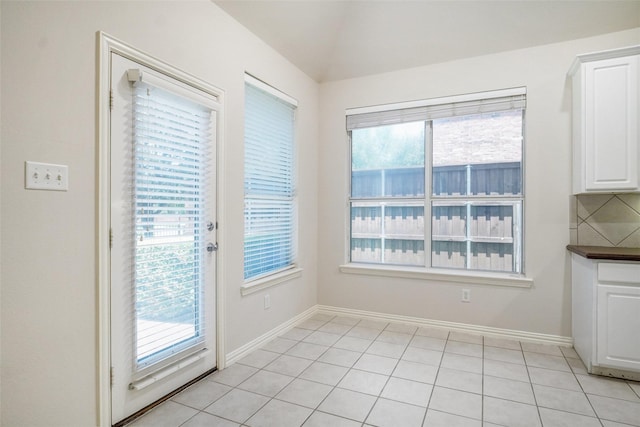 8393 Davis Dr, Frisco, TX 75036 - unfurnished dining area featuring plenty of natural light, baseboards, and light tile patterned floors