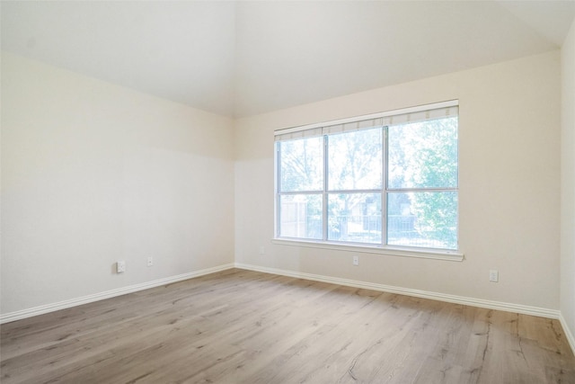 8393 Davis Dr, Frisco, TX 75036 - spare room featuring light wood-style flooring, baseboards, and lofted ceiling