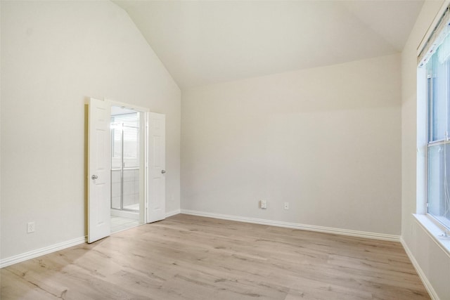 8393 Davis Dr, Frisco, TX 75036 - unfurnished bedroom featuring light wood finished floors, baseboards, high vaulted ceiling, and ensuite bathroom