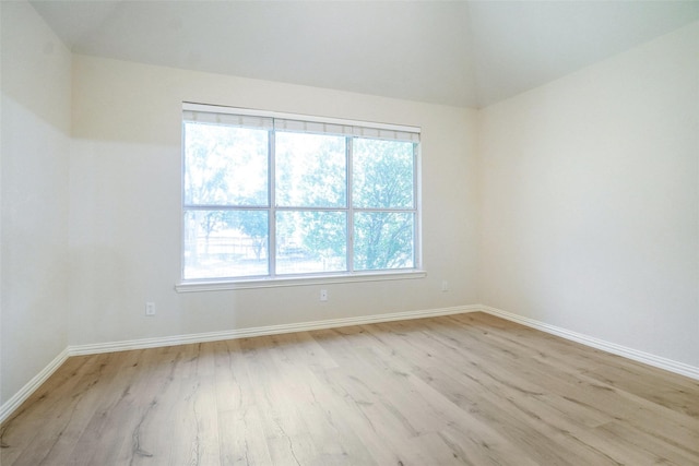 8393 Davis Dr, Frisco, TX 75036 - spare room with light wood-style flooring, baseboards, and lofted ceiling