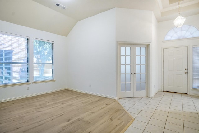 8393 Davis Dr, Frisco, TX 75036 - entryway with light wood-style floors, vaulted ceiling, french doors, and baseboards