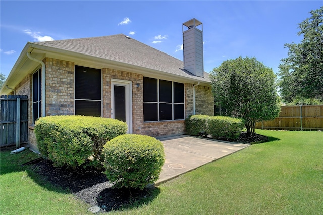 8393 Davis Dr, Frisco, TX 75036 - back of house with brick siding, a chimney, a patio, and roof with shingles