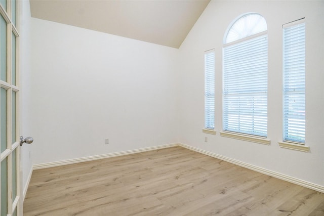 8393 Davis Dr, Frisco, TX 75036 - spare room featuring light wood-style floors, healthy amount of natural light, vaulted ceiling, and baseboards