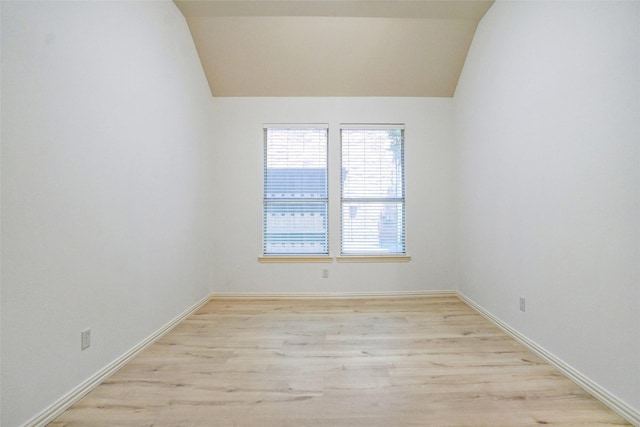 8393 Davis Dr, Frisco, TX 75036 - empty room with lofted ceiling, light wood-type flooring, and baseboards