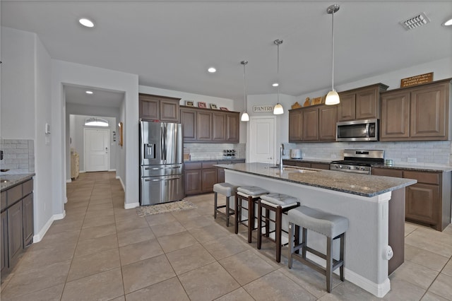 1099 Admiral Dr, Azle, TX 76020 - kitchen featuring stainless steel appliances, backsplash, light tile patterned floors, and recessed lighting