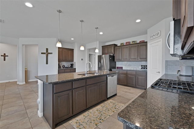 1099 Admiral Dr, Azle, TX 76020 - kitchen featuring stainless steel appliances, backsplash, dark brown cabinets, a kitchen island with sink, and recessed lighting